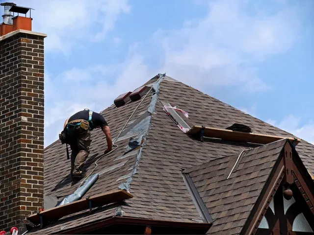 Roofer performing roof repairs on a home in Austin, TX