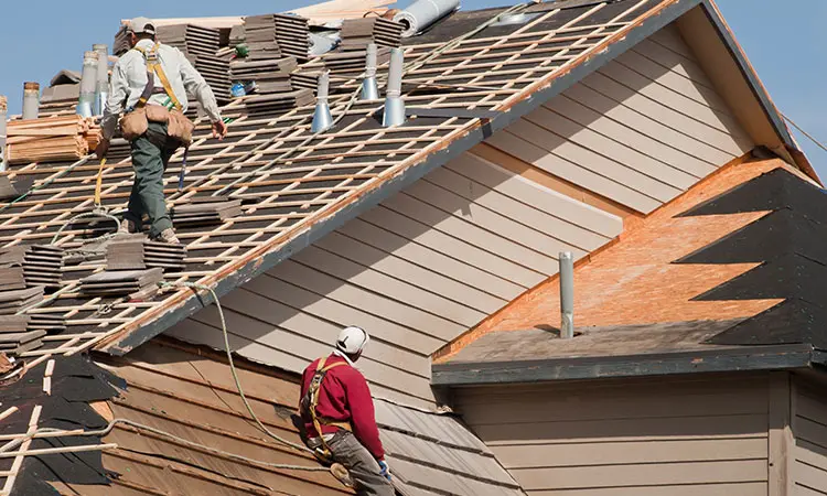 Roofer installing a new roof on a home in Austin, TX