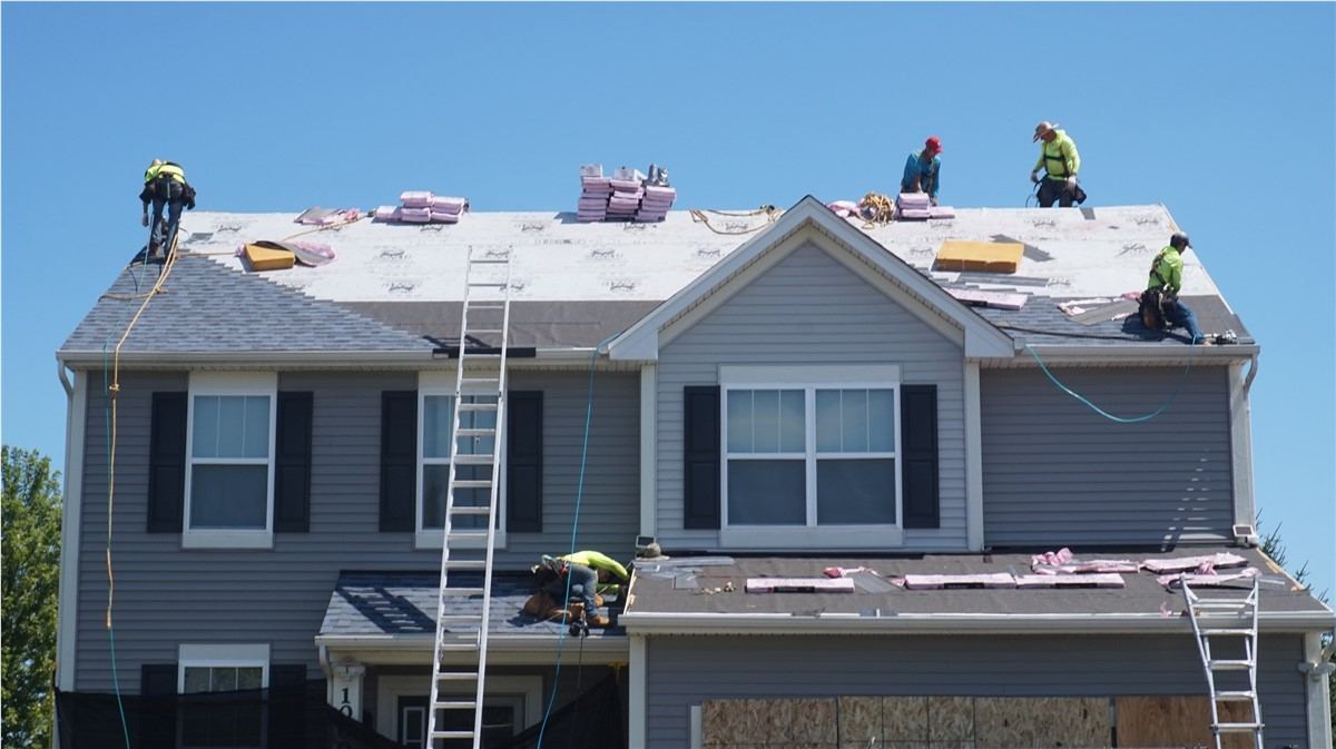 Roofer installing a new roof on a home in Austin, TX