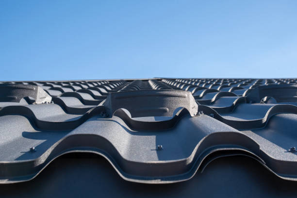 Roof installation crew working safely on sloped residential roof