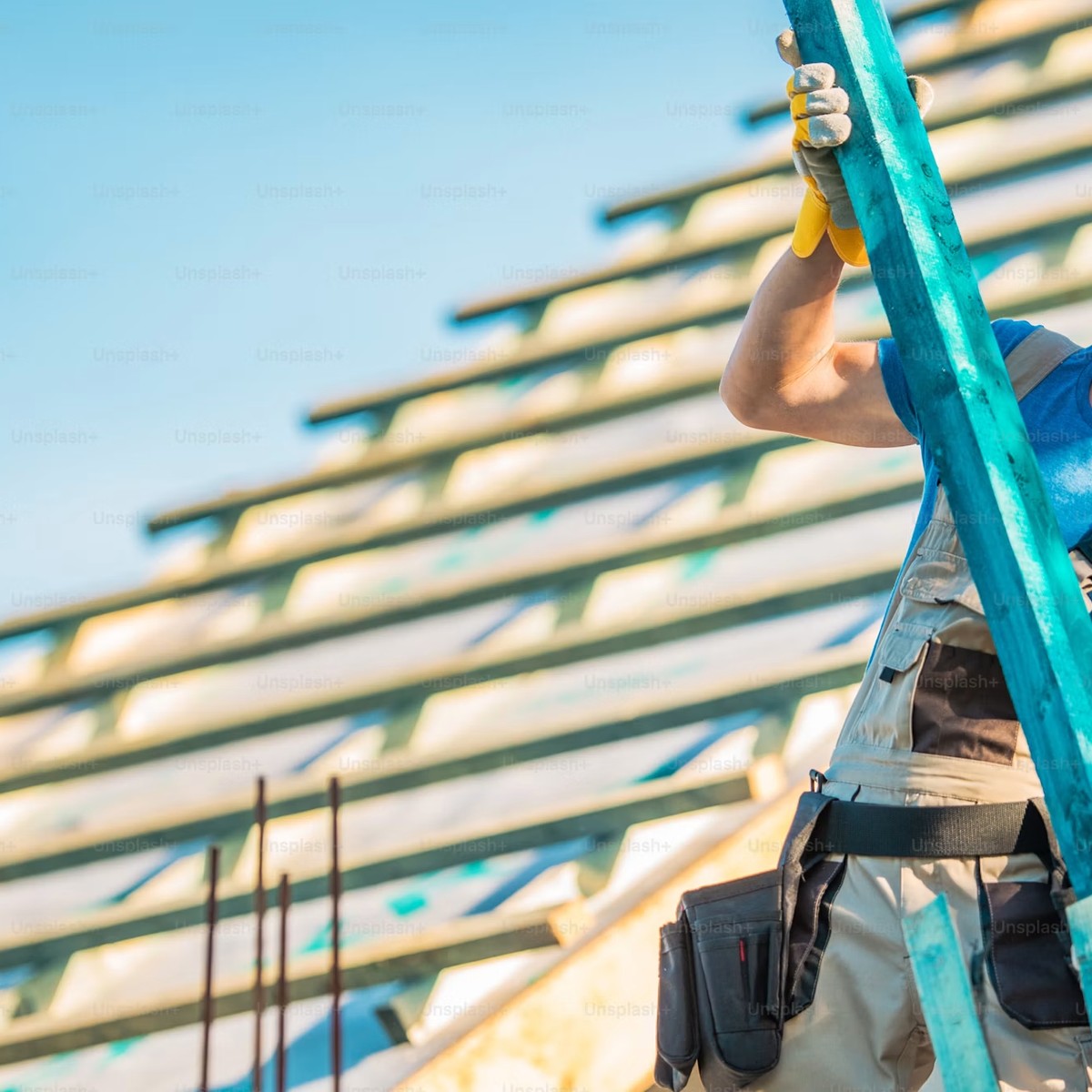 Roofing professional working from a ladder on an exposed roof structure, representing Roofing Repair services near me.