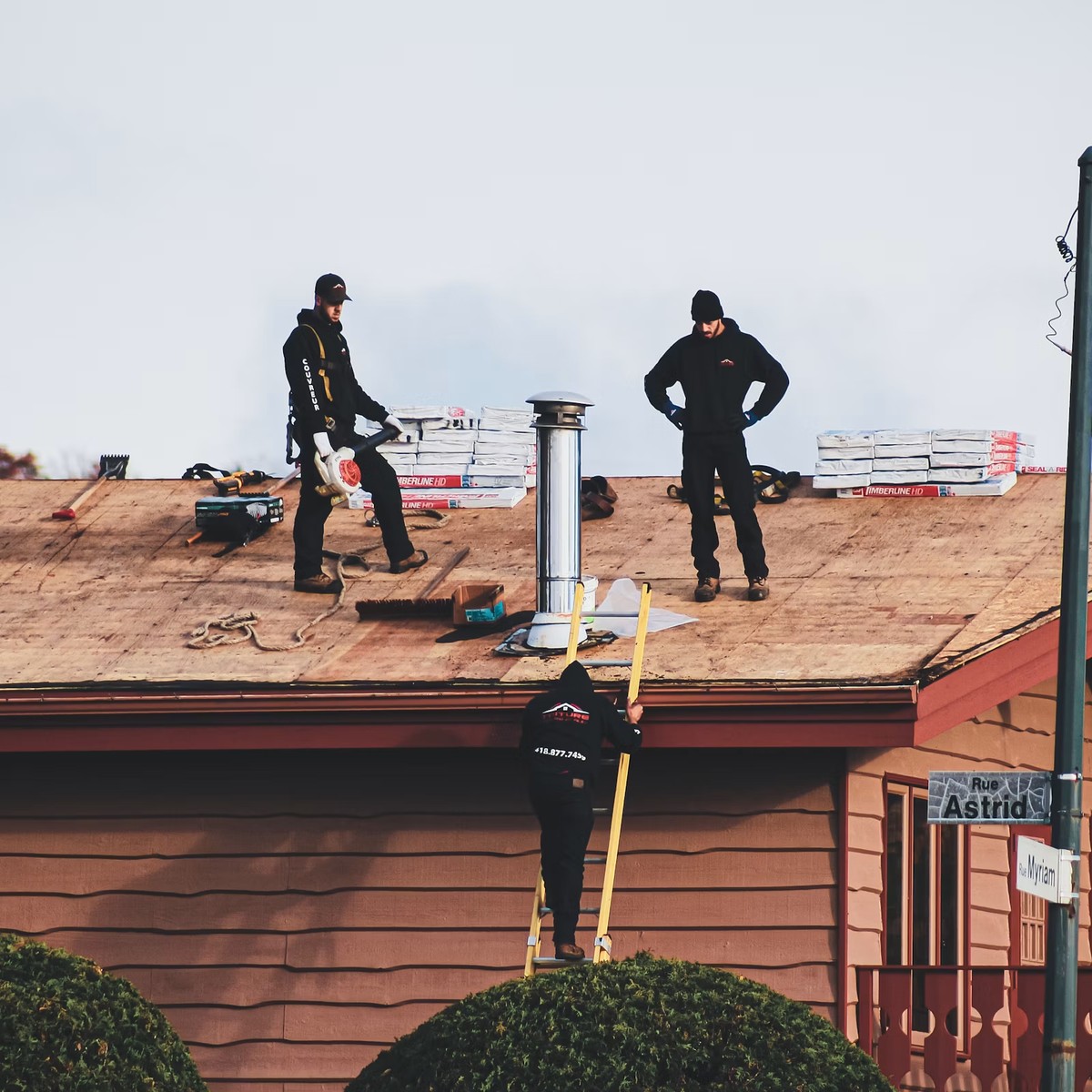 Roofing professionals working on a residential roof, representing Dependable Roofing Repair in Golden, CO.