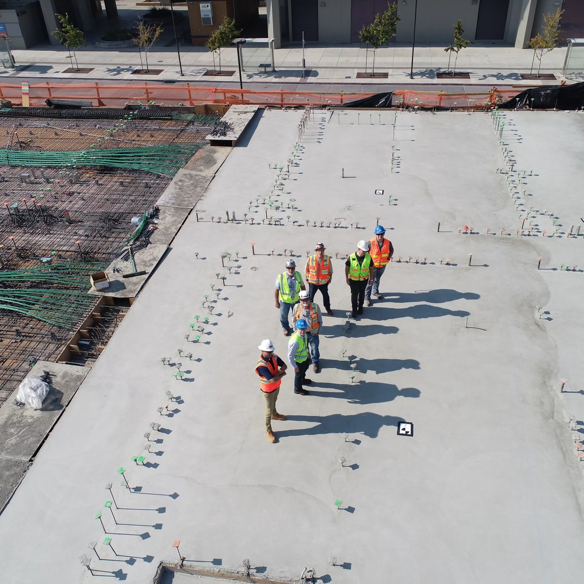 Roofing and construction professionals inspecting a large building surface during active work, representing Trusted Roofing Repair in Conifer, CO.