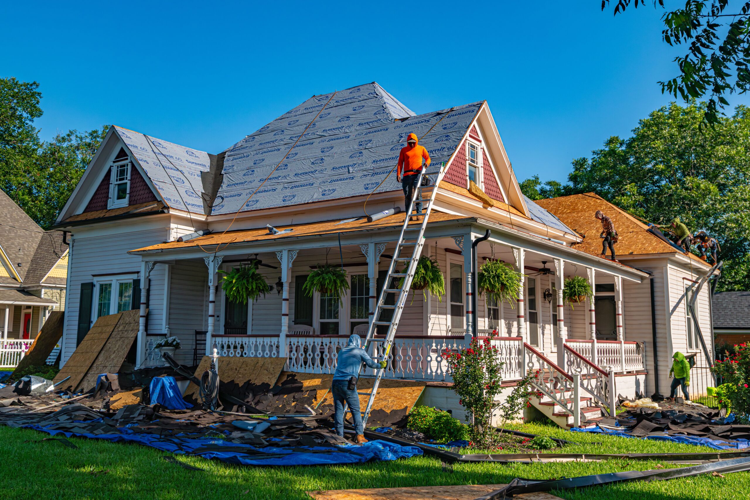Roofing crew replacing the roof on a residential home for roofing services near me