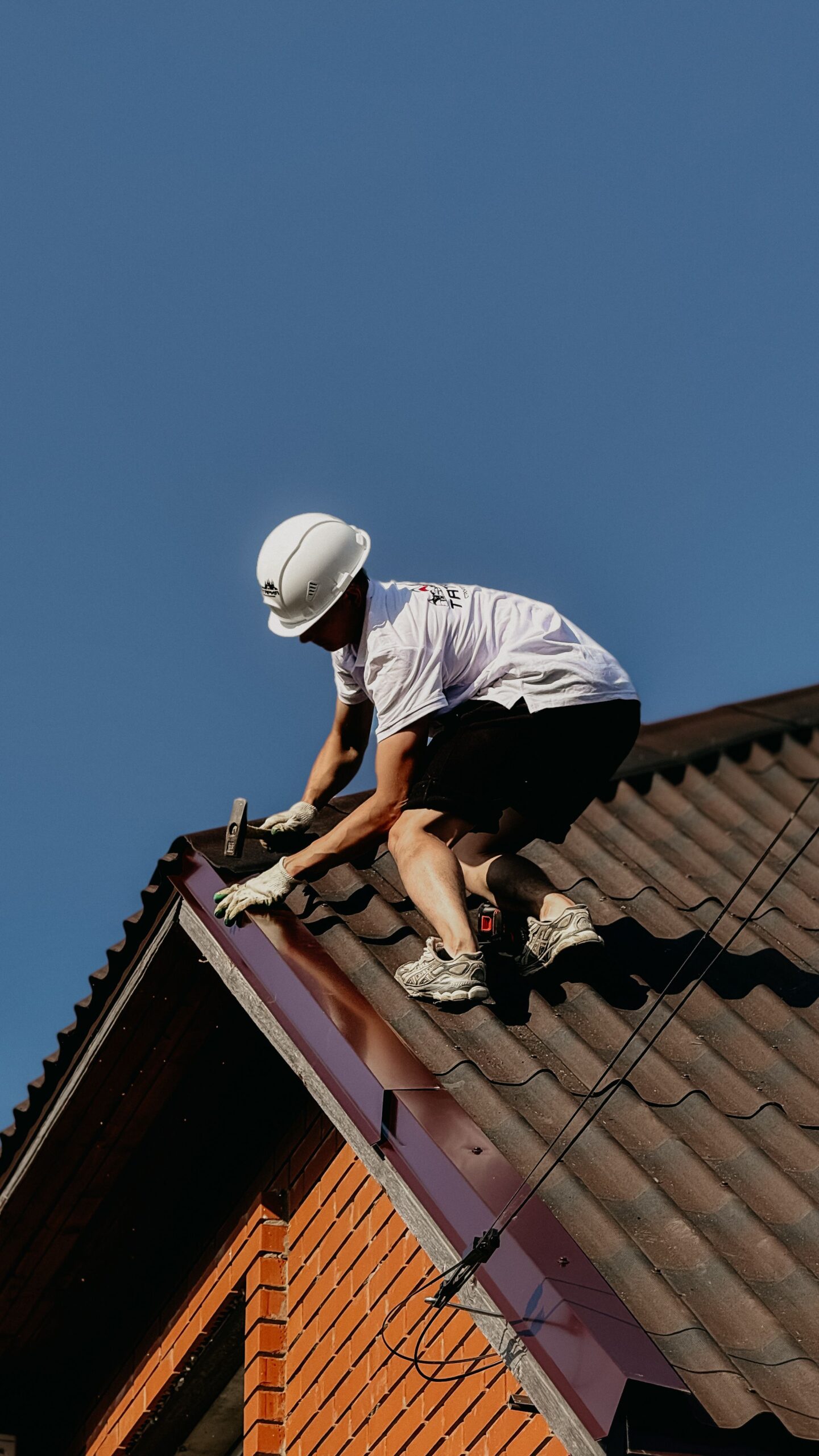 Roofing professional repairing a residential roof for roofing services near me